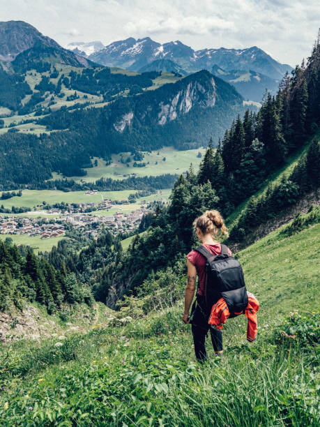 istock Young woman hikes through grassy meadow 1340940314