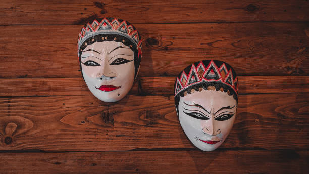istock Wooden mask on a wooden table 1340940514
