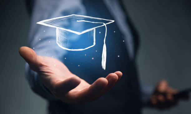 istock holding phone with Graduation cap icon 1340941304