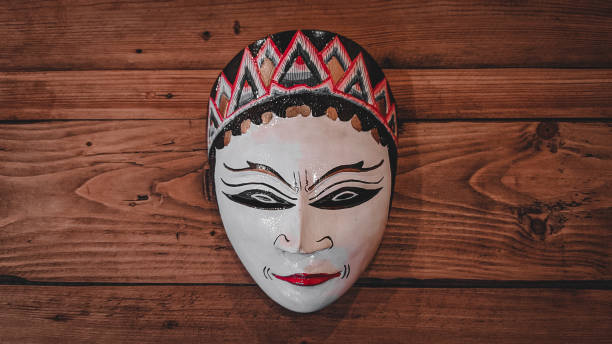 istock Wooden mask on a wooden table 1340941455