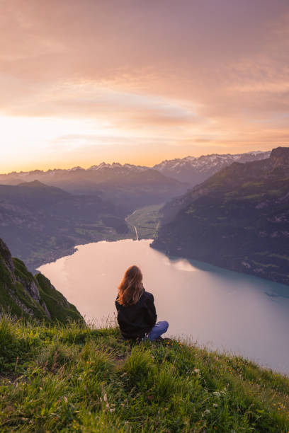 istock Female hiker relaxes on mountain ridge at sunrise 1340941854