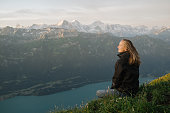 istock Female hiker relaxes on mountain ridge at sunrise 1340941946