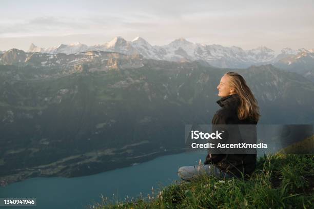 Female Hiker Relaxes On Mountain Ridge At Sunrise Stock Photo - Download Image Now - One Woman Only, Nature, Landscape - Scenery
