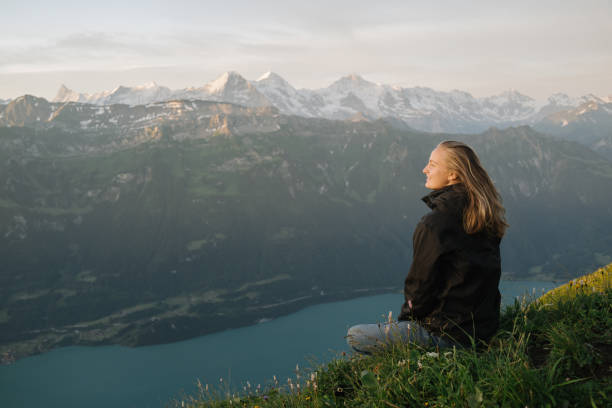 туристка отдыхает на горном хребте на рассвете - mountain sunrise scenics european alps стоковые фото и изображения