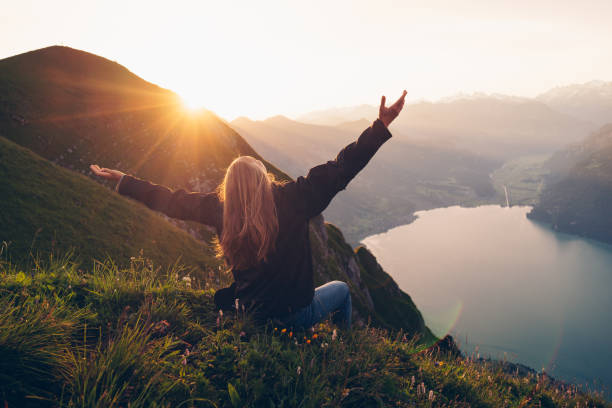 istock Female hiker relaxes on mountain ridge at sunrise 1340942538