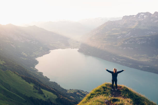 istock Female hiker relaxes on mountain ridge at sunrise 1340942606