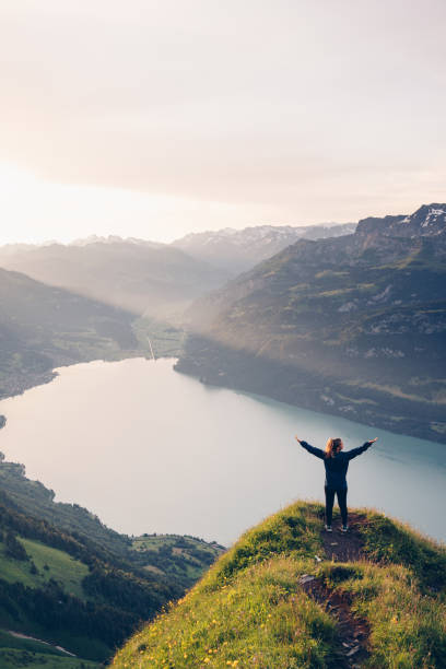 istock Female hiker relaxes on mountain ridge at sunrise 1340942622