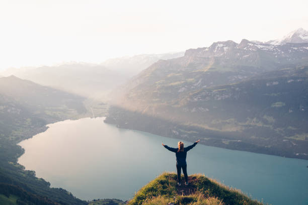istock Female hiker relaxes on mountain ridge at sunrise 1340942634