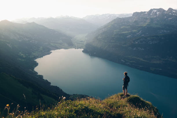 istock Hiker relaxes at viewpoint on mountain, at sunrise 1340942652