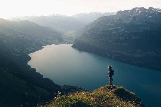 istock Hiker relaxes at viewpoint on mountain, at sunrise 1340942653
