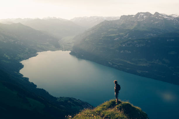 istock Hiker relaxes at viewpoint on mountain, at sunrise 1340942656