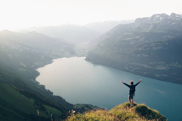 istock Hiker relaxes at viewpoint on mountain, at sunrise 1340942658