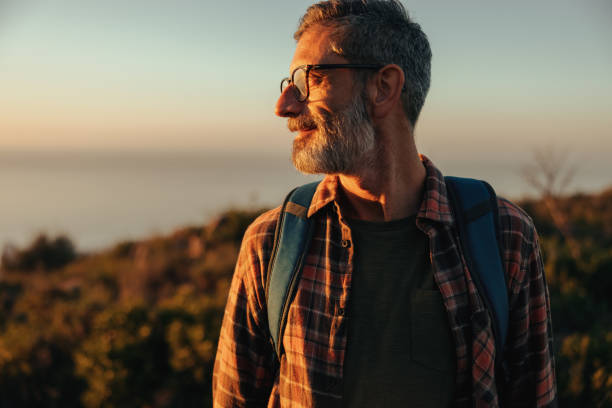 istock Adventurous male hiker looking away while standing on a hilltop 1340942665