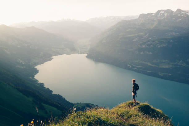 istock Hiker relaxes at viewpoint on mountain, at sunrise 1340942667