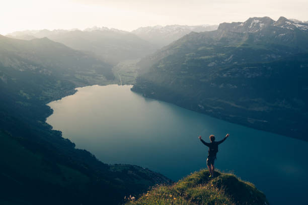 istock Hiker relaxes at viewpoint on mountain, at sunrise 1340942672