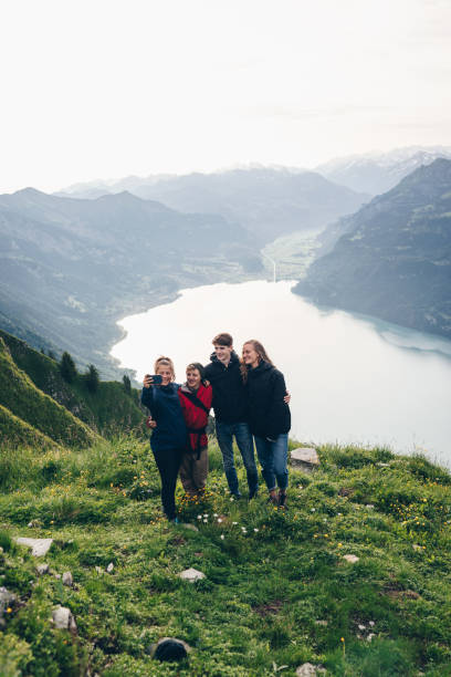 istock Friends relax on mountain ridge and take selfies 1340942701