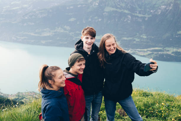 istock Friends relax on mountain ridge and take selfies 1340942746