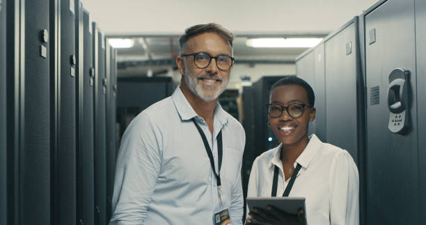 istock Shot of a man and woman using a digital tablet while working in a data centre 1340944089