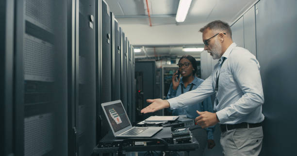 Shot of a man and woman looking stressed while working in a data centre