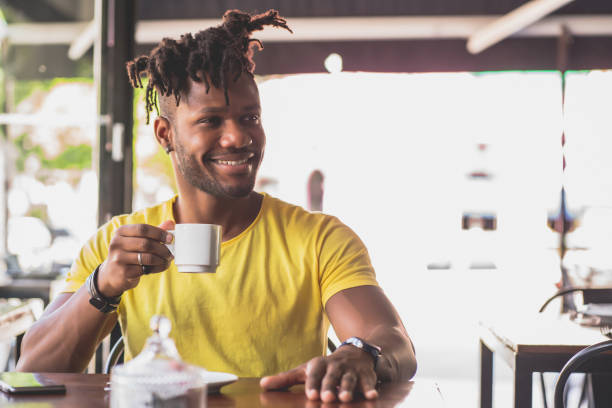 istock Man drinking a cup of coffee at a coffee shop. 1340946150