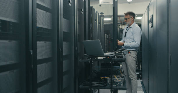 istock Shot of a mature man using a digital tablet and laptop while working in a data centre 1340946351