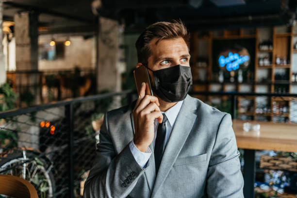 istock Businessman in a restaurant with protective face mask 1340947525