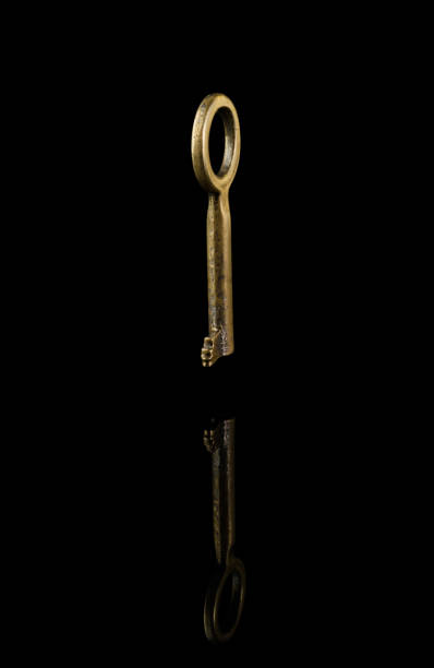 istock Vintage key on a black background isolated, with reflection 1340953788
