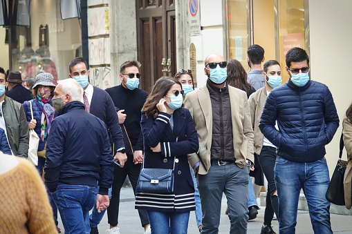 Downtown shopping street crowded with people wearing the covid mask Turin, Italy, October 2020.