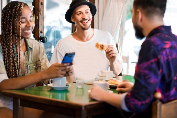 istock Friends enjoying drinking coffee together at a coffee shop. 1340956097