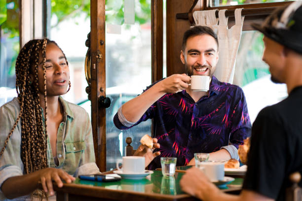 istock Friends enjoying drinking coffee together at a coffee shop. 1340956112