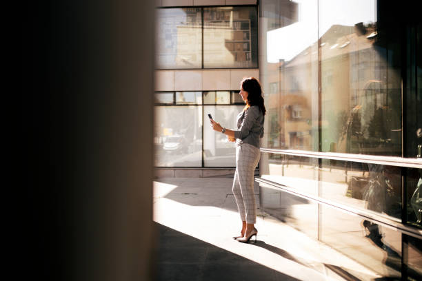istock Businesswoman is using cell phone texting in the morning 1340956974