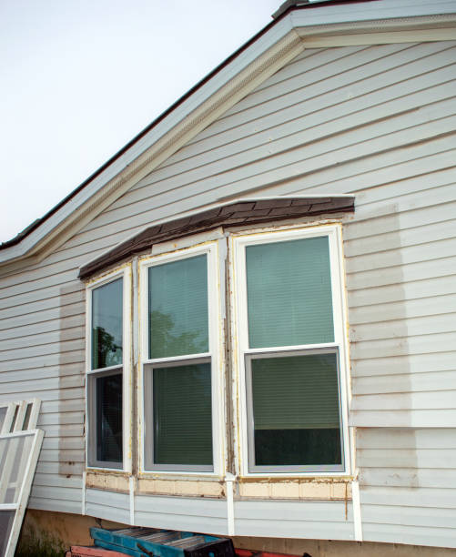 Time for window replacement on this home. Three bay windows are being taken out and will be replaced with nice new tinted storm windows and screens for more energy efficiency. The shutters and trim have been removed. real estate outdoors vertical usa stock pictures, royalty-free photos & images