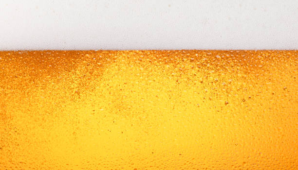 istock Close up background of beer with bubbles in glass 1340960175