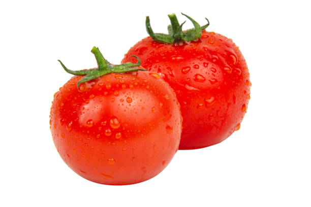 istock Fresh red tomatoes with wet drops isolated on the white background 1340963383