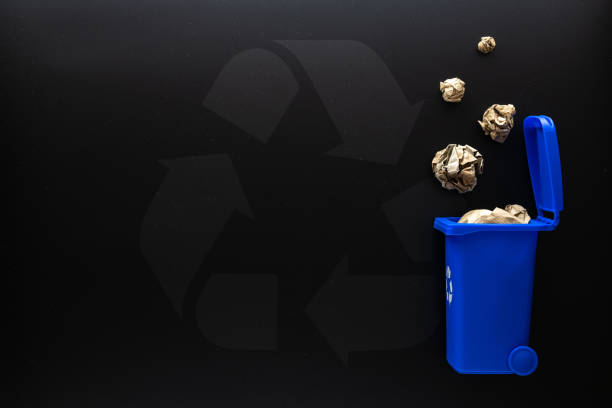 istock Recycle paper garbage. Blue dustbin for recycle paper trash on black background. Bin container for disposal garbage waste and save environment. Copy space. 1340964146