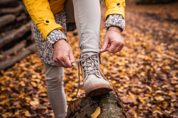 Woman tying shoelace on her hiking boot