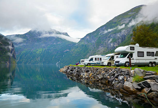 Camping by fjord Motorhomes at campsite by the Geirangerfjord in Norway geirangerfjord stock pictures, royalty-free photos & images