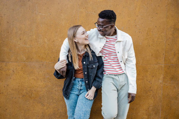 istock Multi-ethnic couple in front of orange wall 1340965845