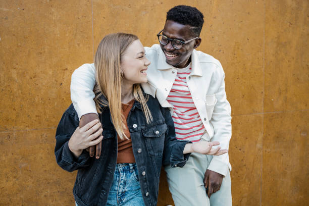 istock Multi-ethnic couple in front of orange wall 1340966485