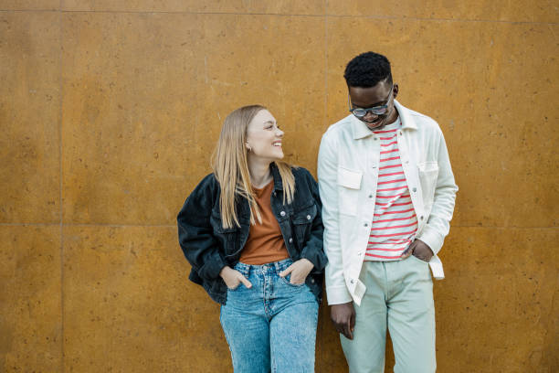 istock Multi-ethnic couple in front of orange wall 1340966598