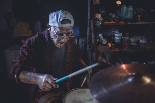 istock An older man practices playing drums in his garage 1340968052