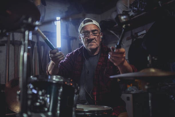 istock An older man practices playing drums in his garage 1340968061