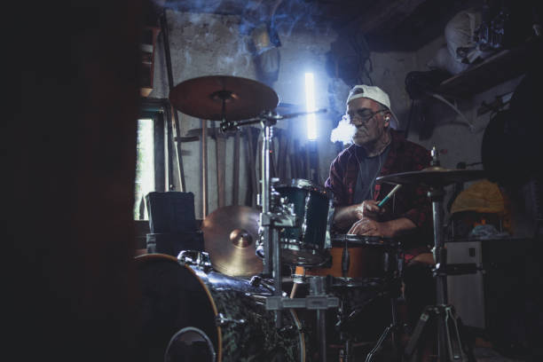 istock An older man practices playing drums in his garage 1340968070