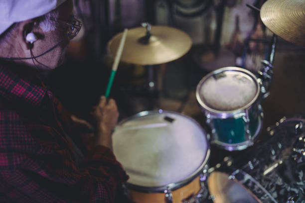 istock An older man practices playing drums in his garage 1340968953