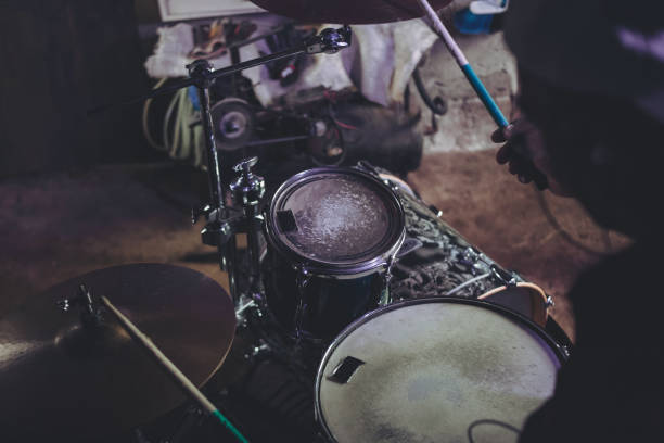 istock An older man practices playing drums in his garage 1340968954