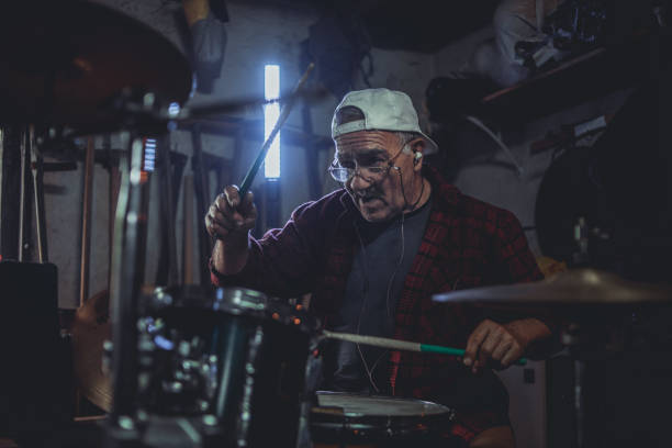 The older man, the older man who practices playing drums in his garage, reminds him of the days when he ruled the stage at concerts.