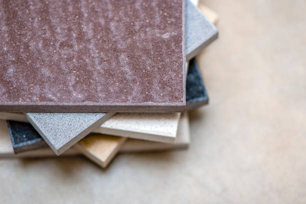 istock Samples of natural stone for kitchen countertops and floor tiles. Stone samples for countertops on gray background, copy space for design or text 1340969917