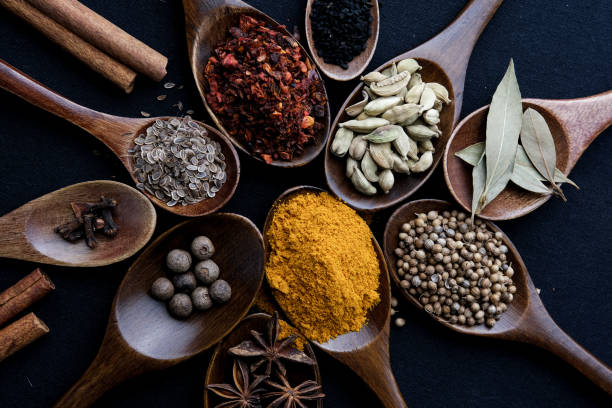 istock Colourful various herbs and spices for cooking on dark background. 1340970113