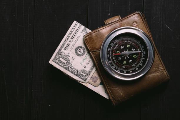 istock vintage banknotes on wooden board with old vintage compass 1340970347