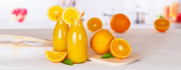 istock Orange juice drink in bottle on wooden board panorama copyspace copy space 1340971569